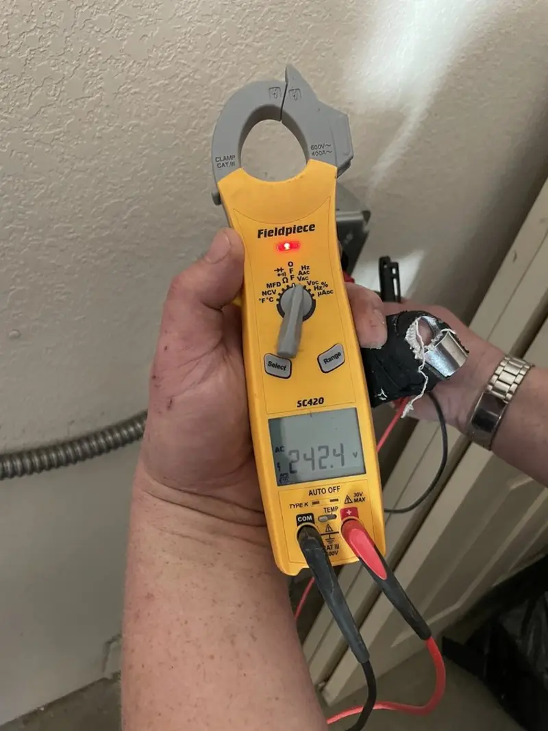 Voltage testing with clamp meter during Outlet Installation in Grand Blanc